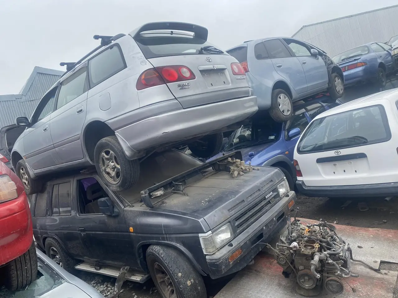 Stacked scrap cars ready for recycling in Christchurch