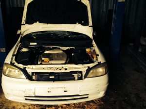 A DEOL Car Solutions wrecker is in the process of dismantling a written-off Mitsubishi car